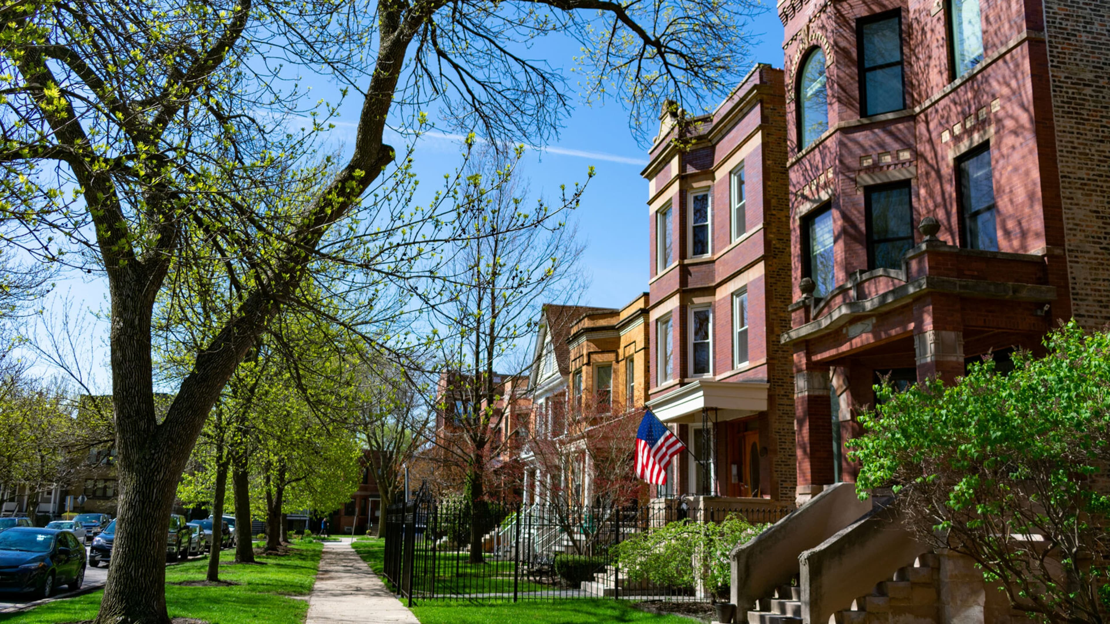 Tree-lined street of brick multifamily buildings