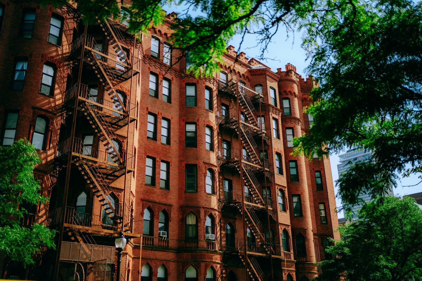 Classic red brick apartment building with fire escapes