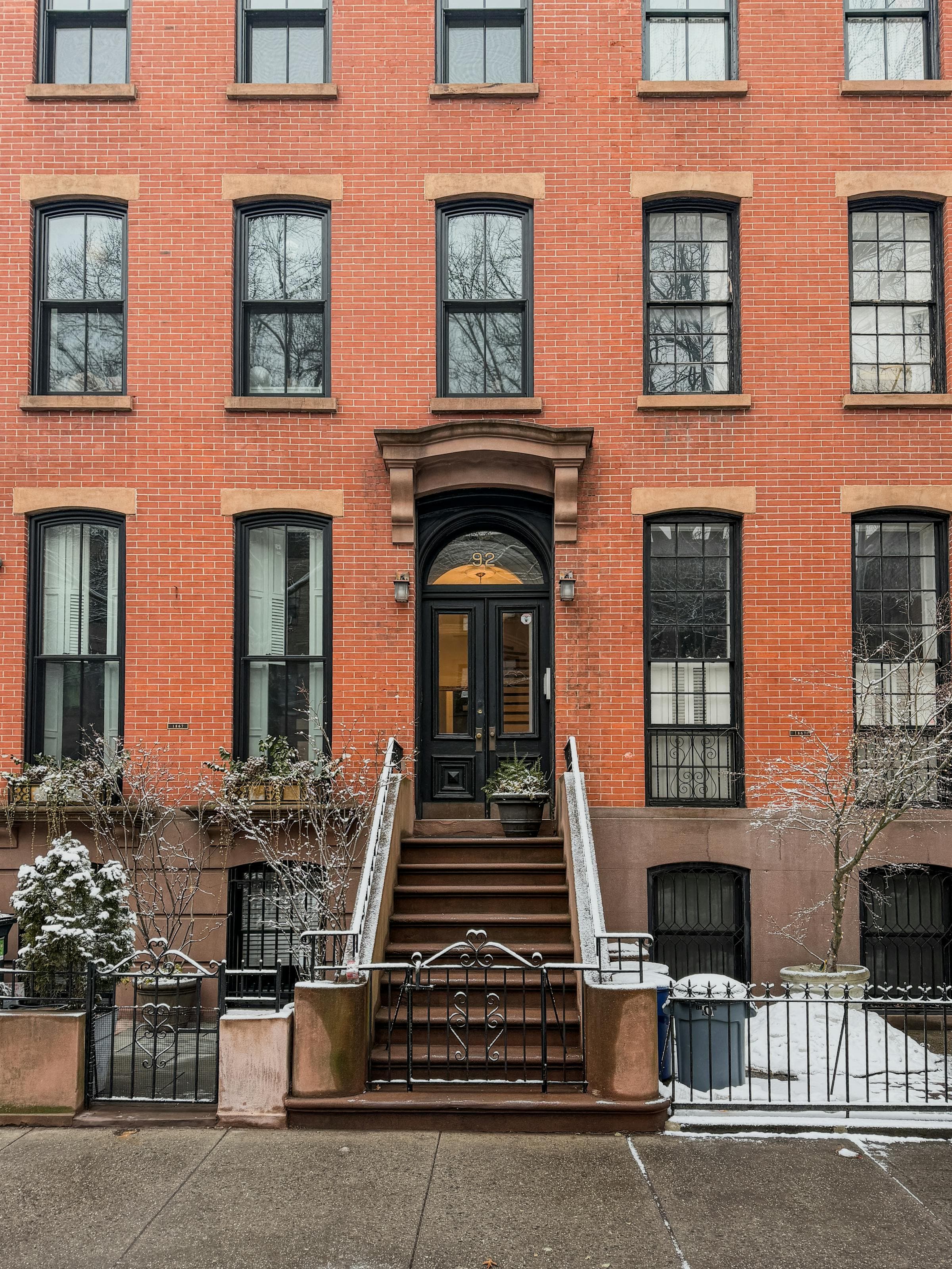 Classic red brick apartment building with arched entryway